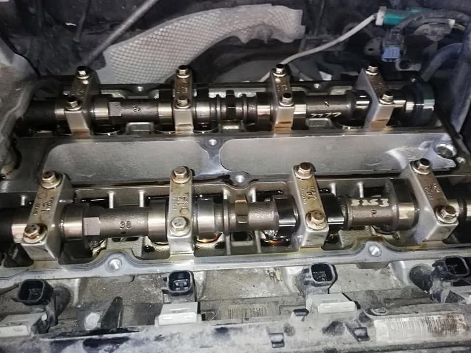 A clean twin-cam cylinder head with both camshafts and bearing caps refitted and torqued down