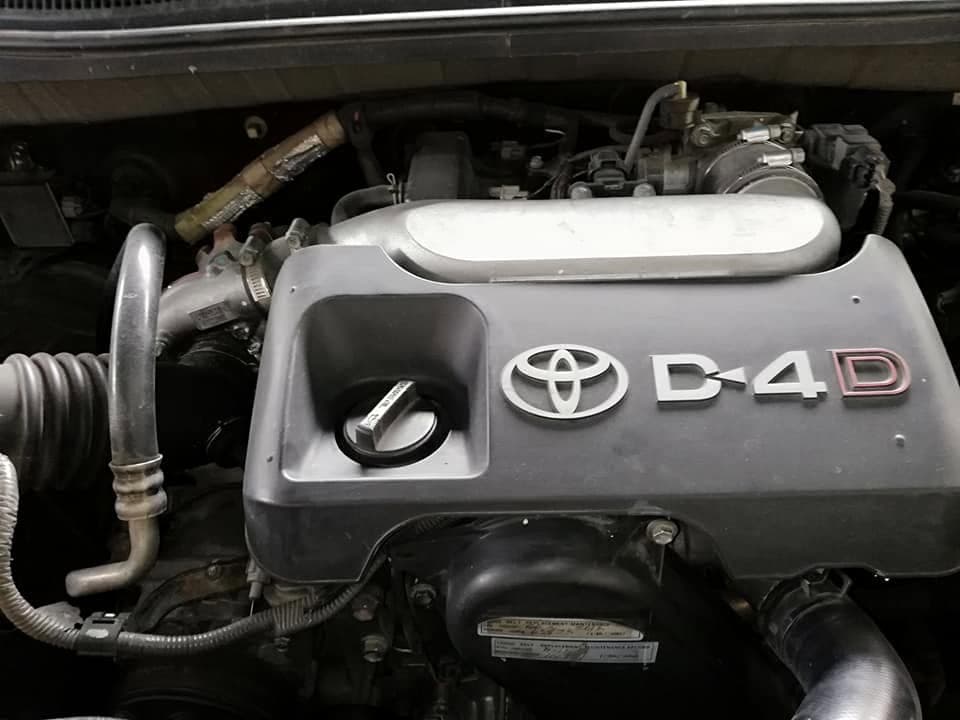 The engine bay of a Toyota diesel showing the D-4D engine cover, intake pipework and turbo plumbing